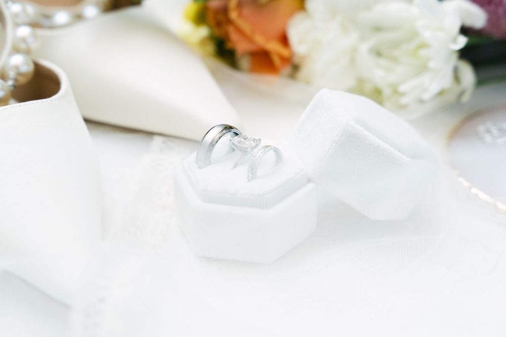 wedding rings placed on soft white fabric during bridal preparation
