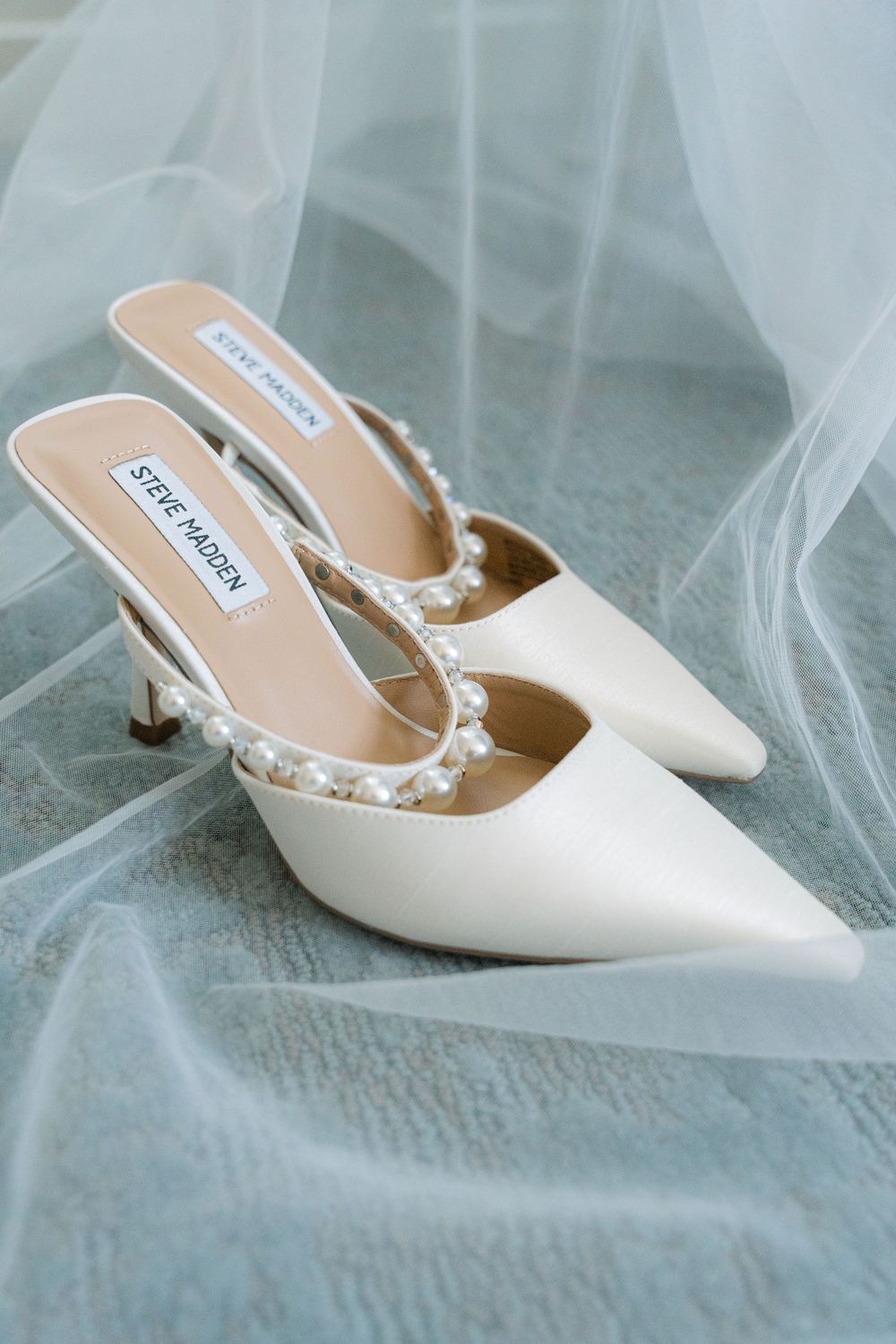 bridal heels styled on sheer fabric during wedding details photography