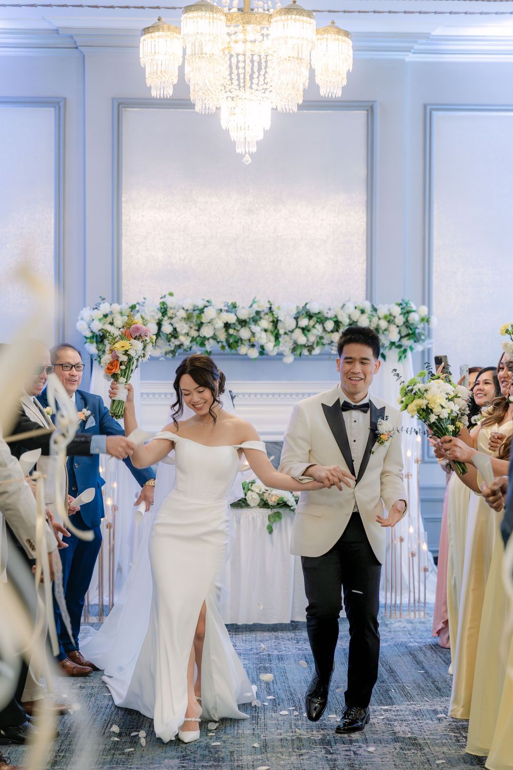 bride and groom walking together down the aisle during an indoor wedding ceremony
