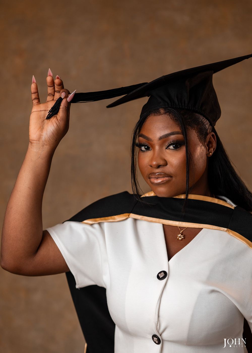 A series of connected portrait photos showing someone posing in a white top and black hat against a brown backdrop.