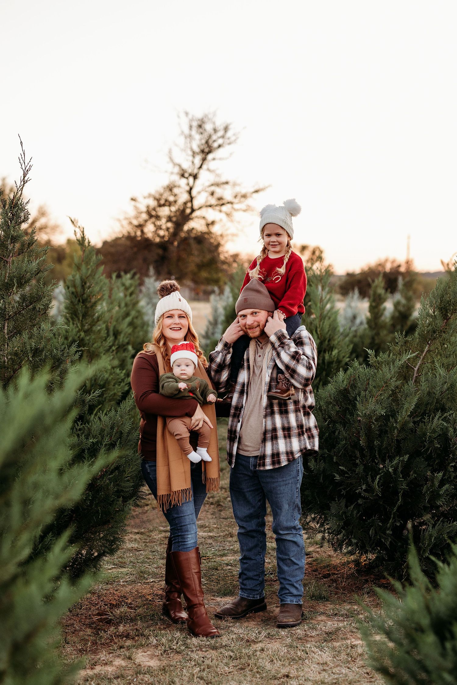 Joyful moment between parent and child wearing matching burgundy outfits outdoors.