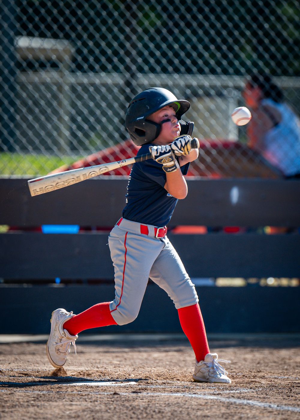 Baseball player swinging at pitch.