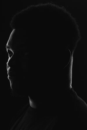 A series of black and white profile silhouettes against a dark background showing different angles of a head.