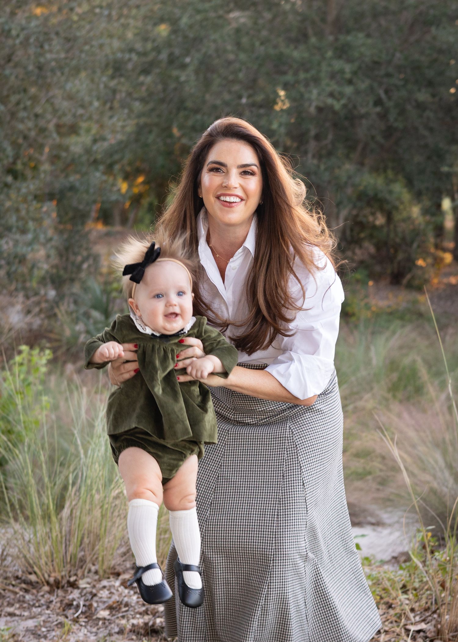 A mom and child playing together outdoors in a natural setting during autumn. Fall Mini Session.