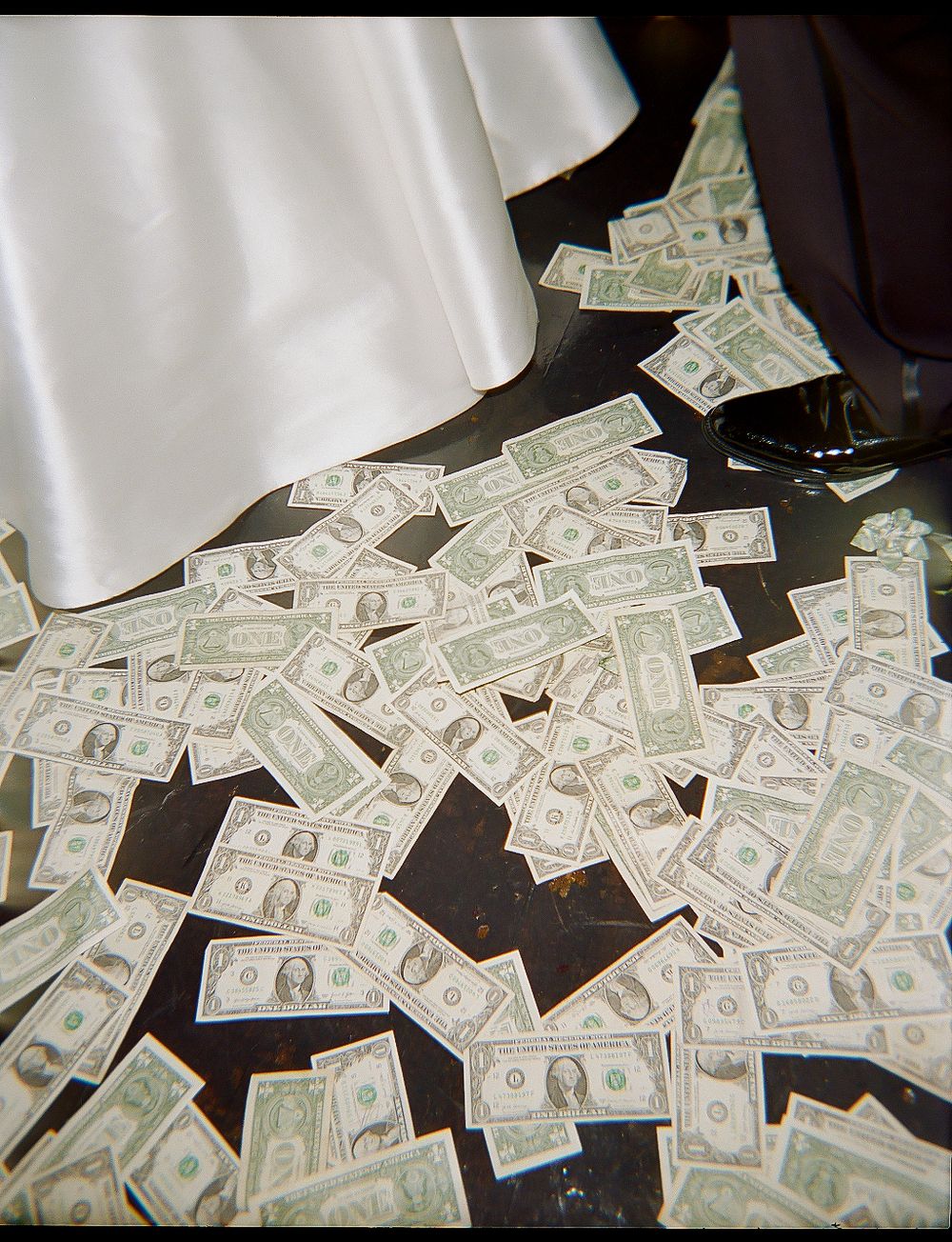 A sequence of five photos showing scattered US dollar bills spread across a dark surface.