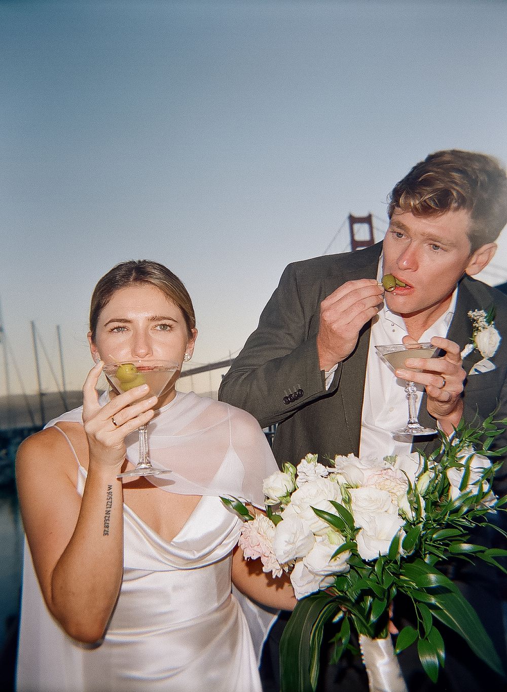 A sequence of artistic photographs showing a person with white roses blowing bubbles against a blue background.