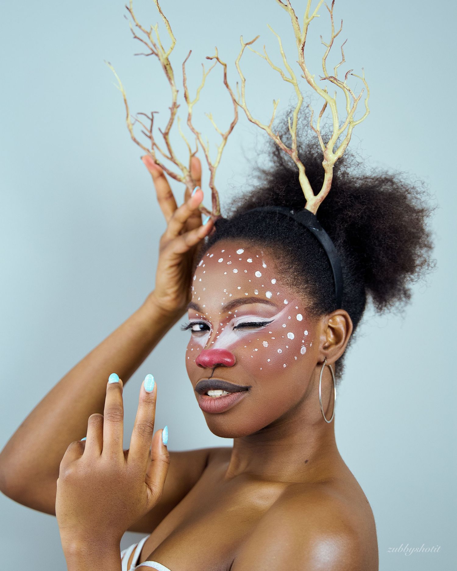 A model wearing antlers looking like a raindeer
