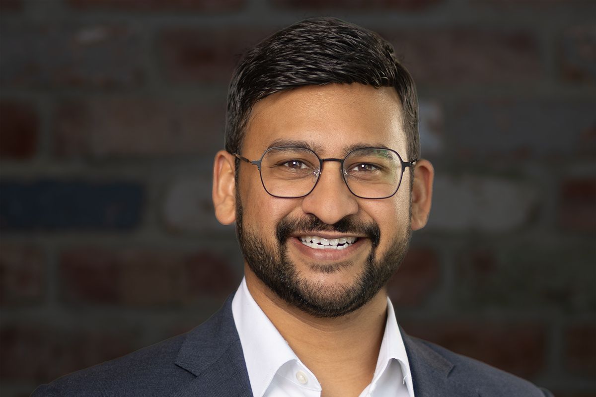Business professional headshot with confident expression and studio lighting
