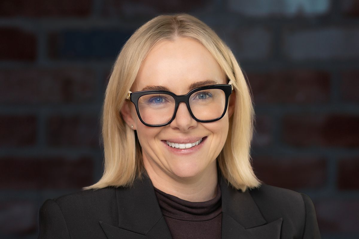 Business professional headshot with confident expression and studio lighting”