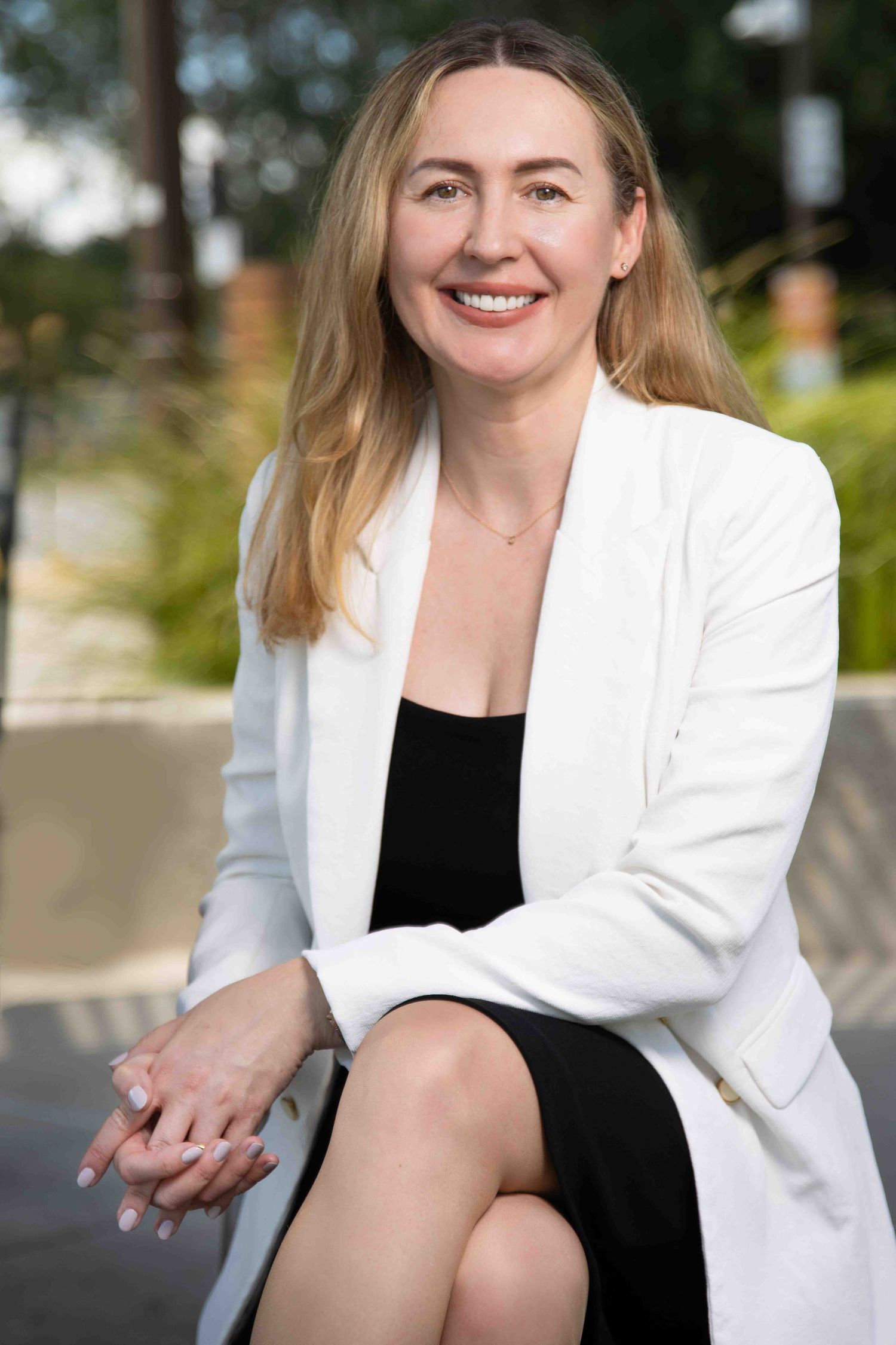 Business professional headshot with confident expression and studio lighting