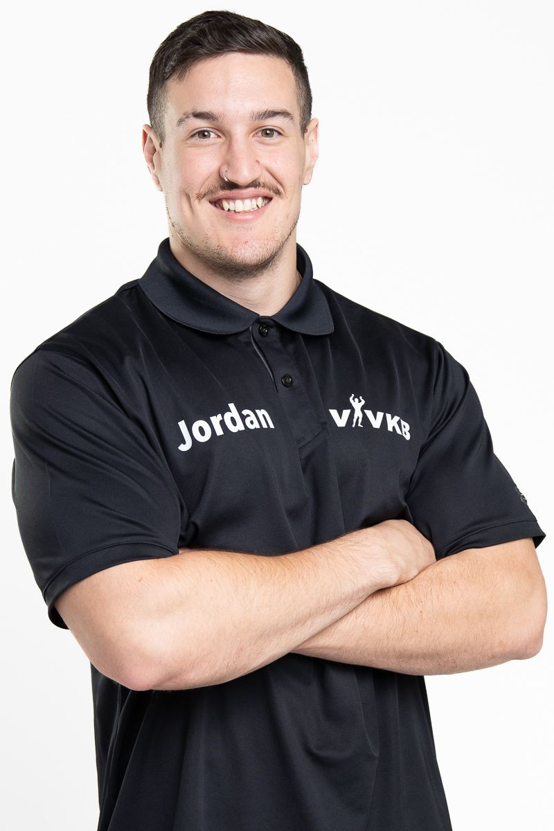 Business professional headshot with confident expression and studio lighting