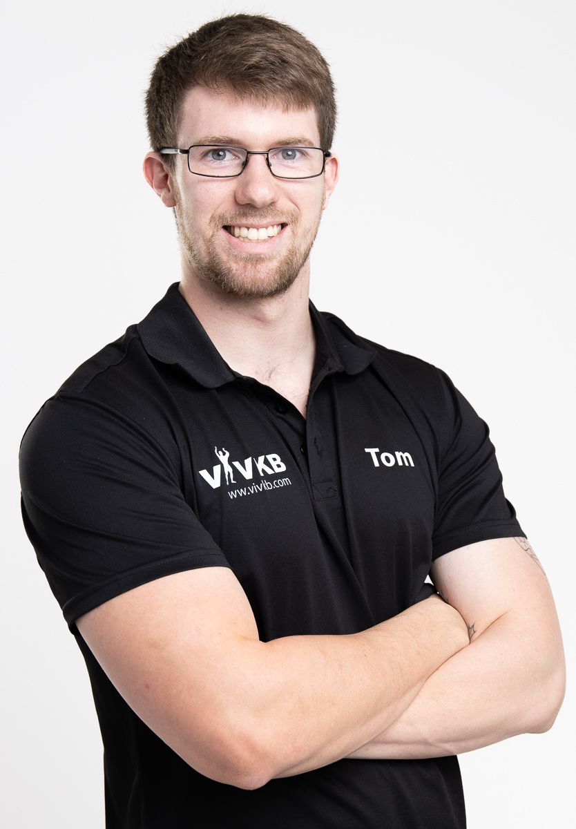 Business professional headshot with confident expression and studio lighting