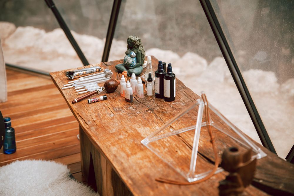 Wooden table with craft supplies and tools arranged for a creative project.