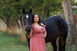 A beautiful girl poses with her lifelong equine friend.