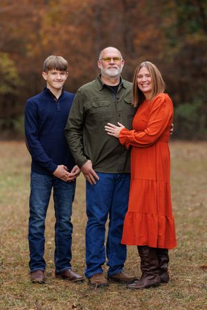 A couple poses with their teenage son for a family portrait.