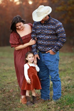 The cutest little western family session in fall colors in front of fall foliage.
