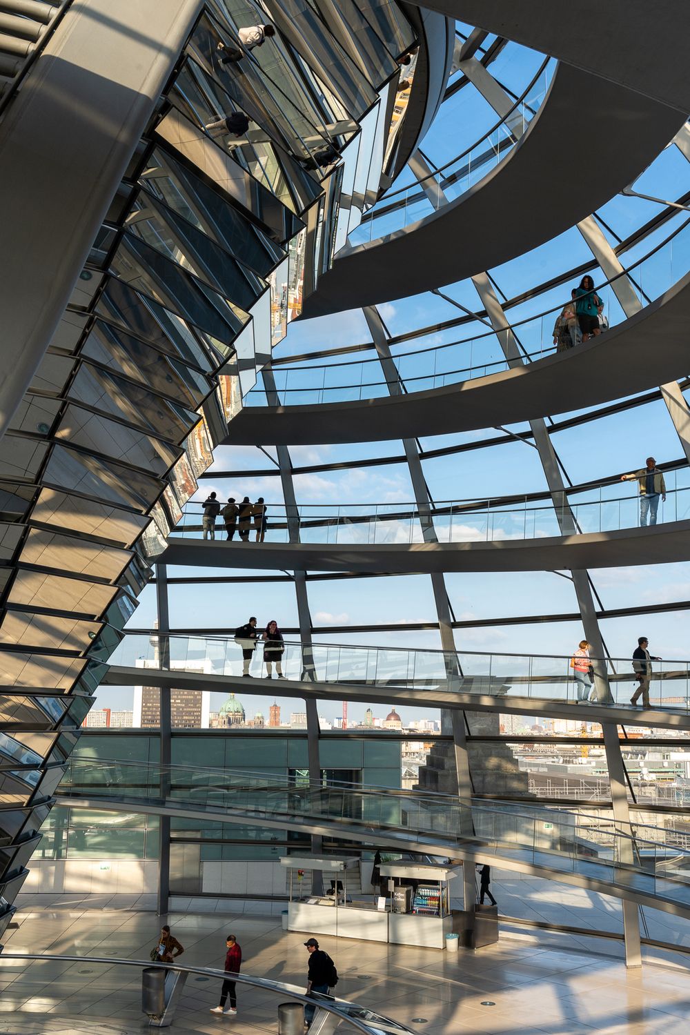Modern spiral walkway inside Reichstag dome with glass and steel architecture.