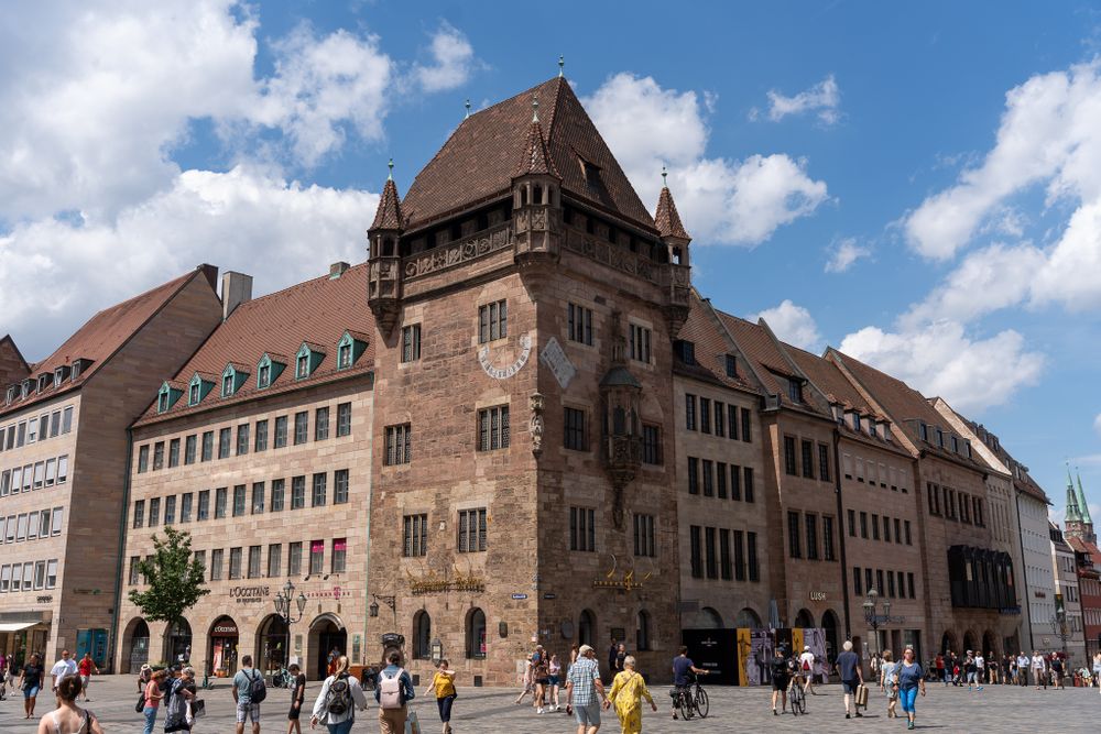 Historic medieval building with distinctive architecture stands prominently in a German city square.