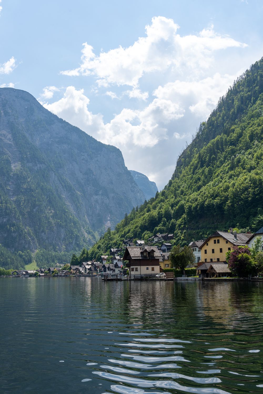 Picturesque lakeside village of Hallstatt nestled between steep mountains in the Austrian Alps.