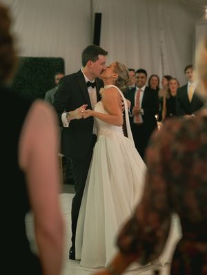 Elegant wedding reception with dancing couples in formal attire.