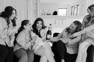 Black and white photo series showing bride and bridesmaids opening champagne