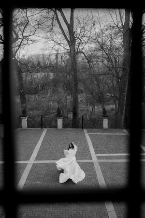 Bride spinning like a princess. Picture taken through a window.