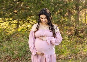 expecting mother holding her belly posing for a picture