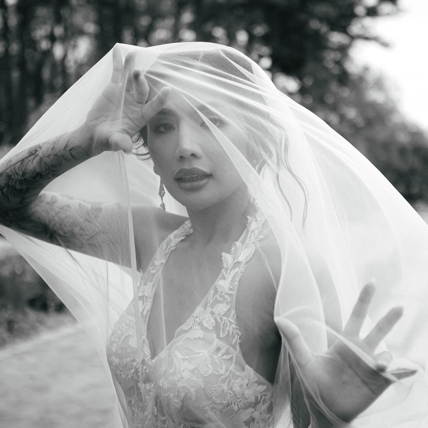 Artistic black and white bridal portraits with flowing veil and lace dress details.