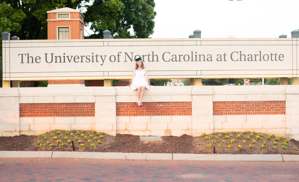 Wide view of UNC Charlotte campus building entrance with brick architecture.