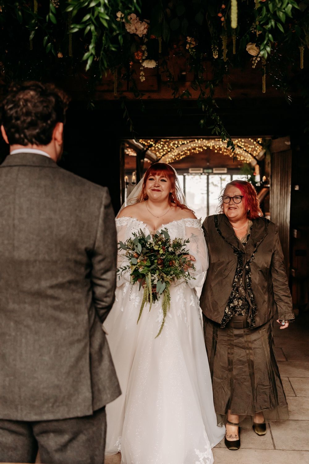 A candid wedding sequence showing joyful moments between a couple in a rustic indoor venue with greenery details.