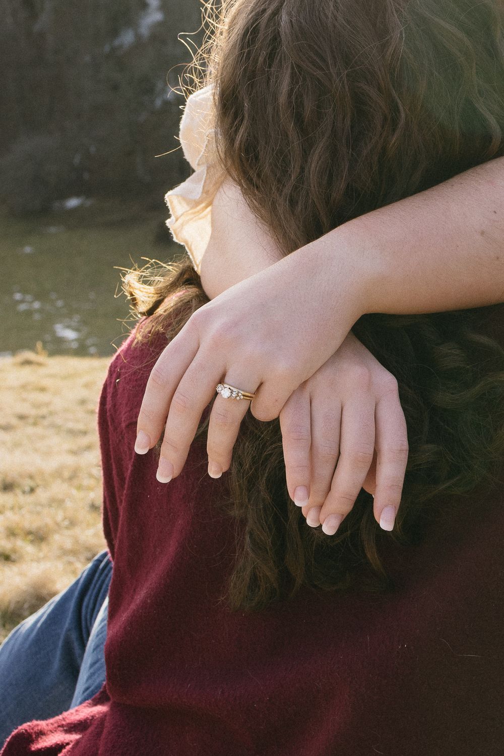 Close-up of hands with an engagement ring embracing outdoors in natural light. Linbrook Heritage Estate Wedding Photographer