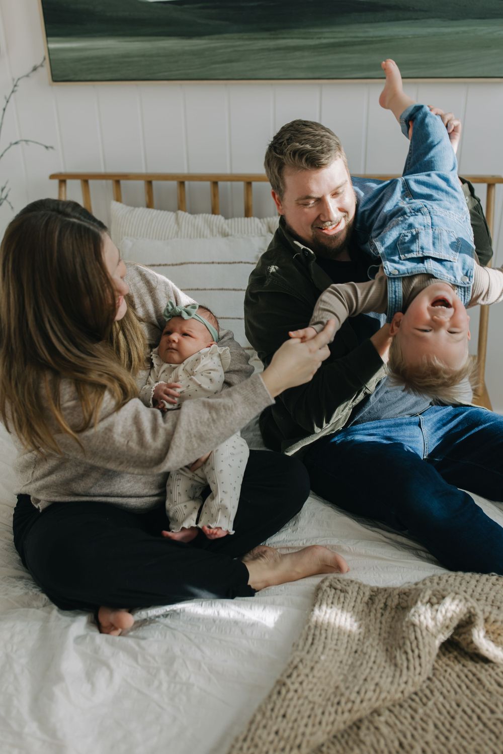 Joyful family interaction captured in sequence on white bedding.