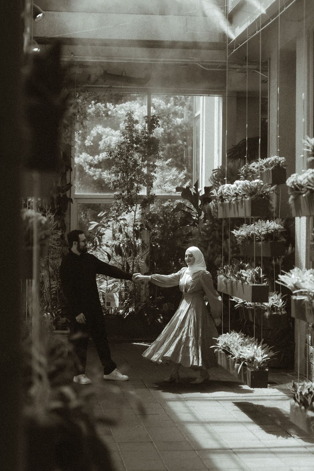 Vintage-style black and white photograph of wedding celebration with floral decorations.
