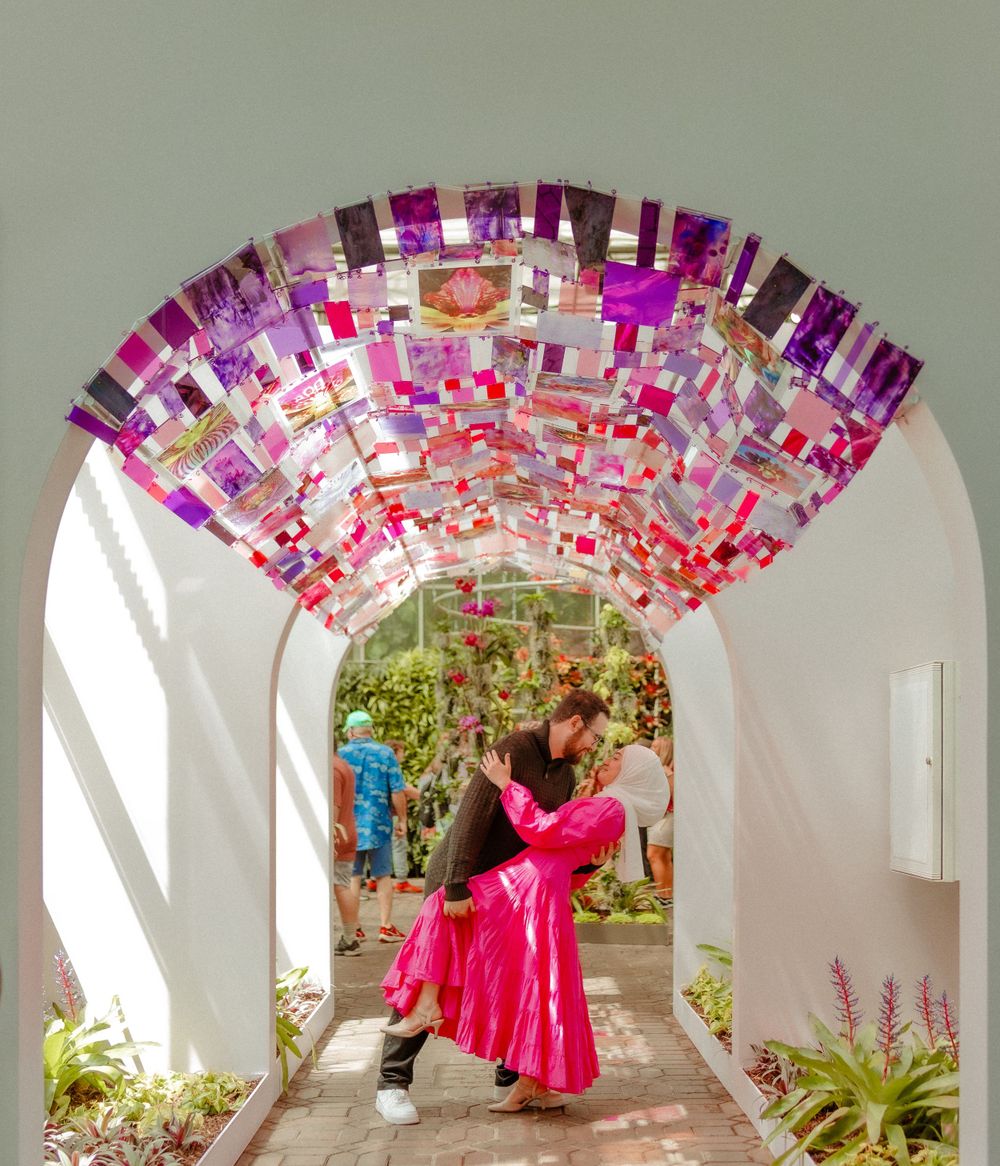 Decorative archway with pink and purple hanging elements creating magical corridor effect.