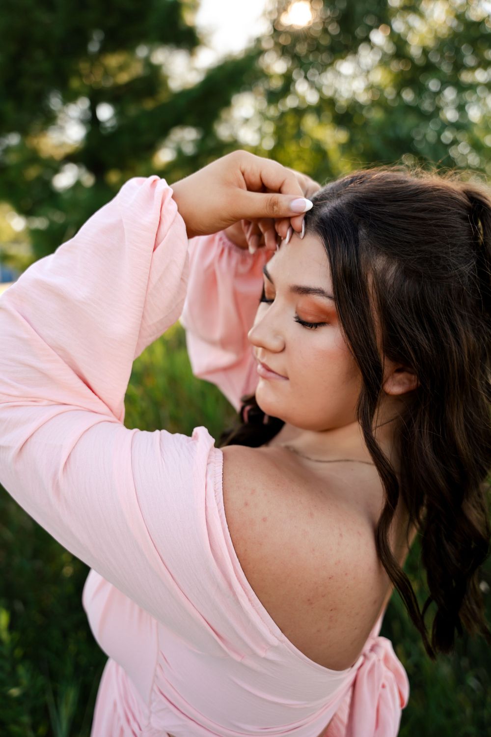 Soft pink dress portraits with graceful poses in golden evening light.