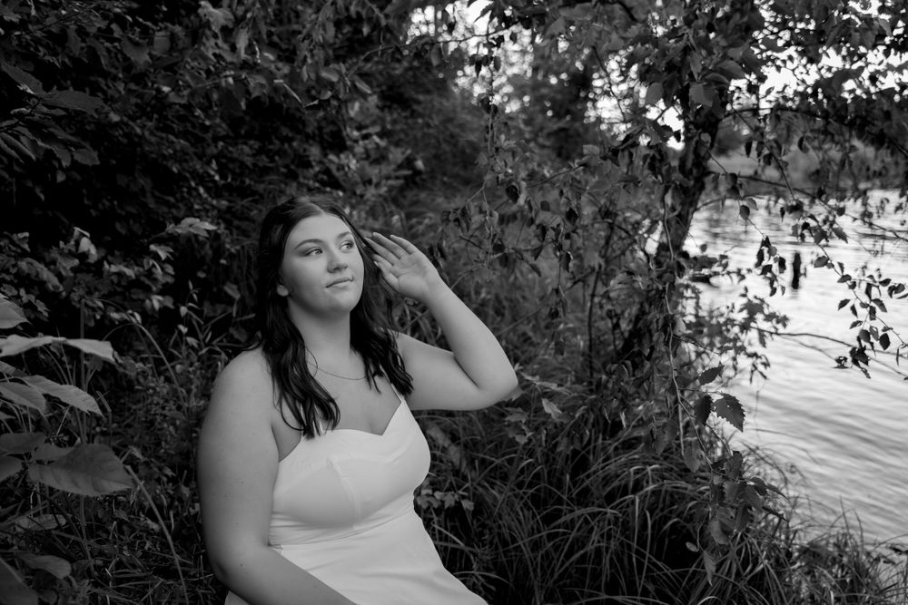 Black and white artistic portrait with natural outdoor lighting.