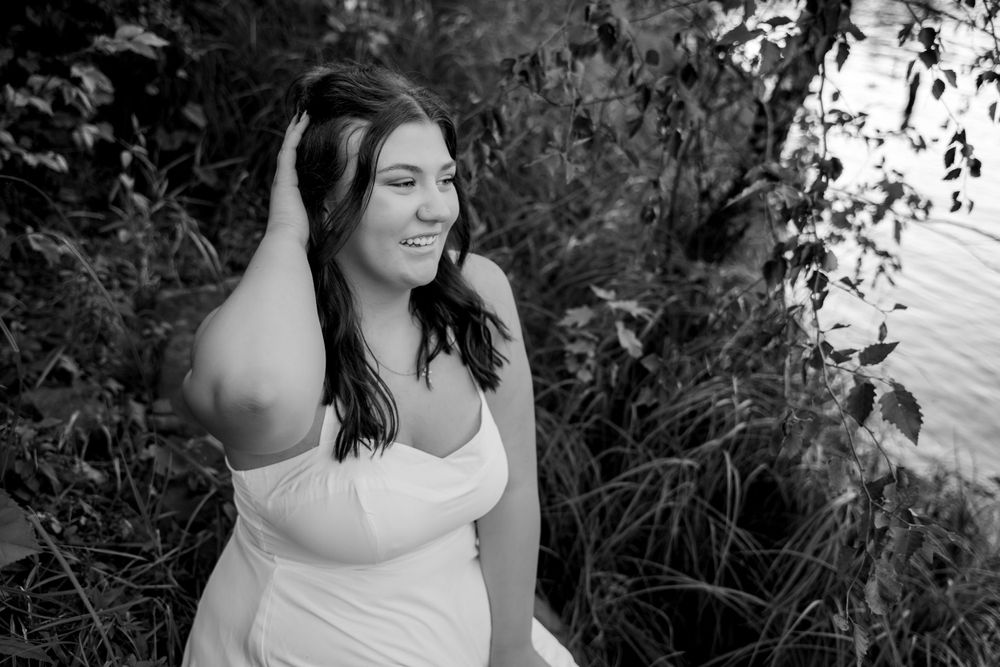 Monochrome portrait series with natural lighting and organic background elements.