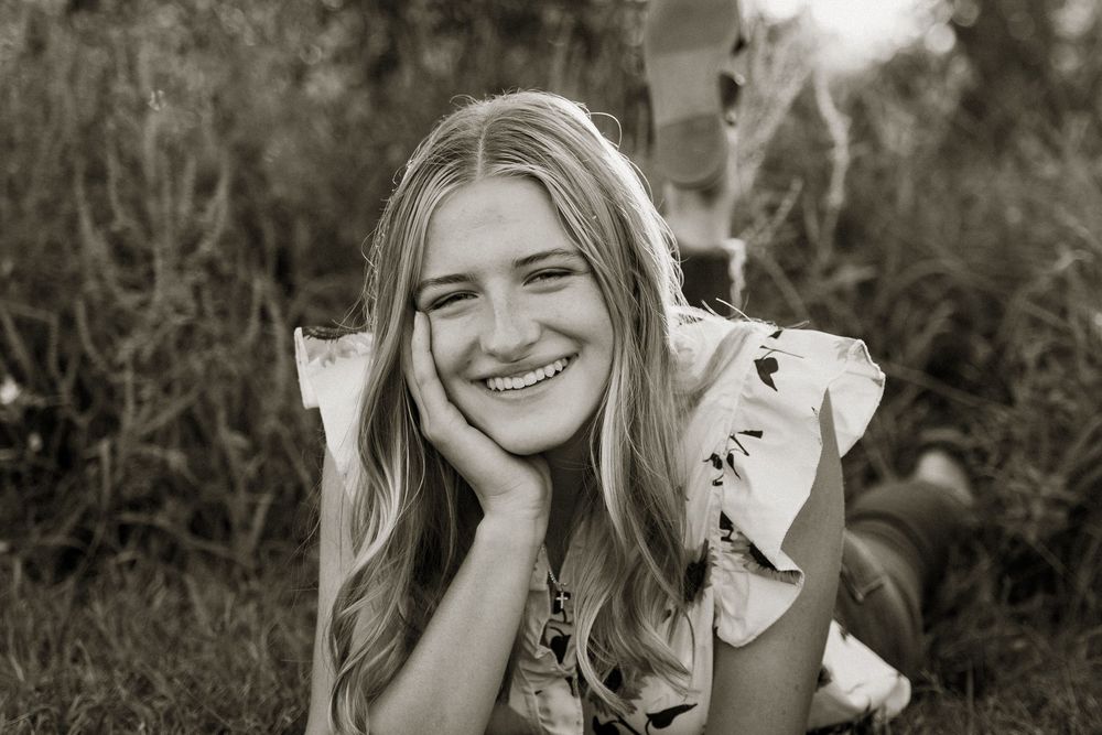 Black and white portrait series showing joyful expressions outdoors.