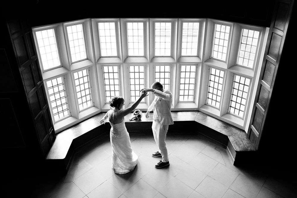 Panoramic view of a bright sunlit room with large bay windows.