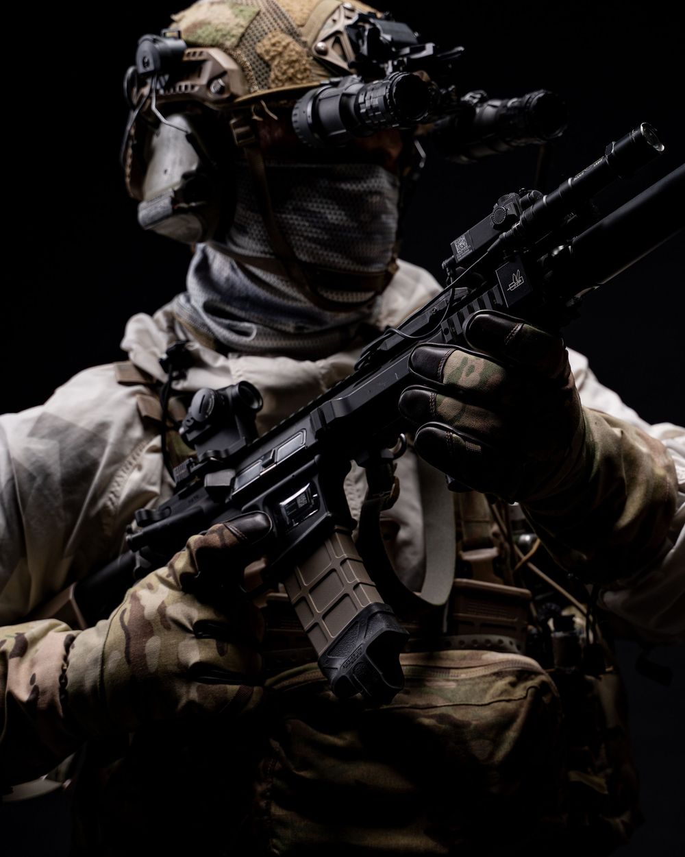 A tactical operator in desert camouflage gear holds a modern assault rifle in a dark setting.