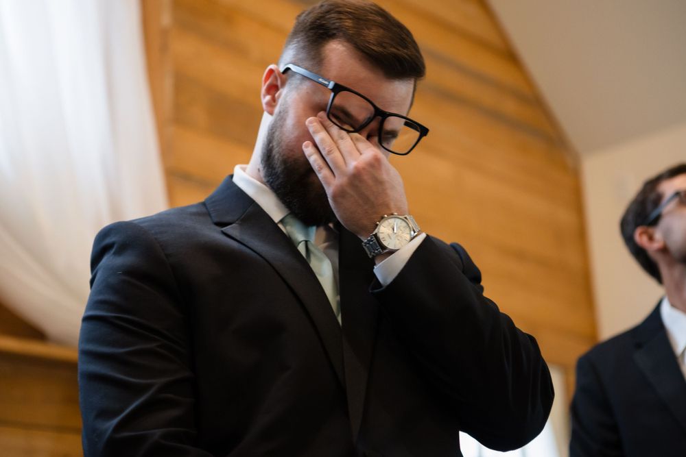 Groom overcome with emotion as bride enters the room.