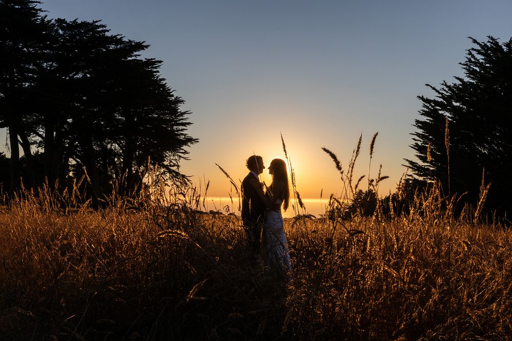 Couple's silhouette against sunset—candid imagery by a destination wedding photojournalist in Mendocino.