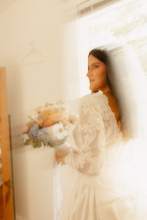 Ethereal bridal portraits with soft natural window light creating dreamy motion blur effects.