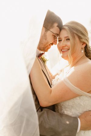 Romantic wedding portrait sequence with sunlit veil creating dreamy atmosphere.