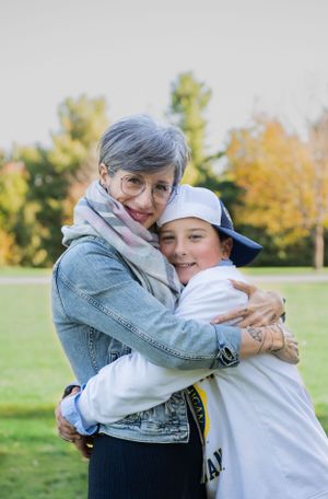 An embrace shared between two people on a sunny autumn day in a park.