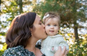 A tender outdoor portrait captured in warm sunlight during a fall afternoon.