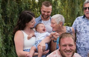 A candid moment of laughter shared between family members outdoors.