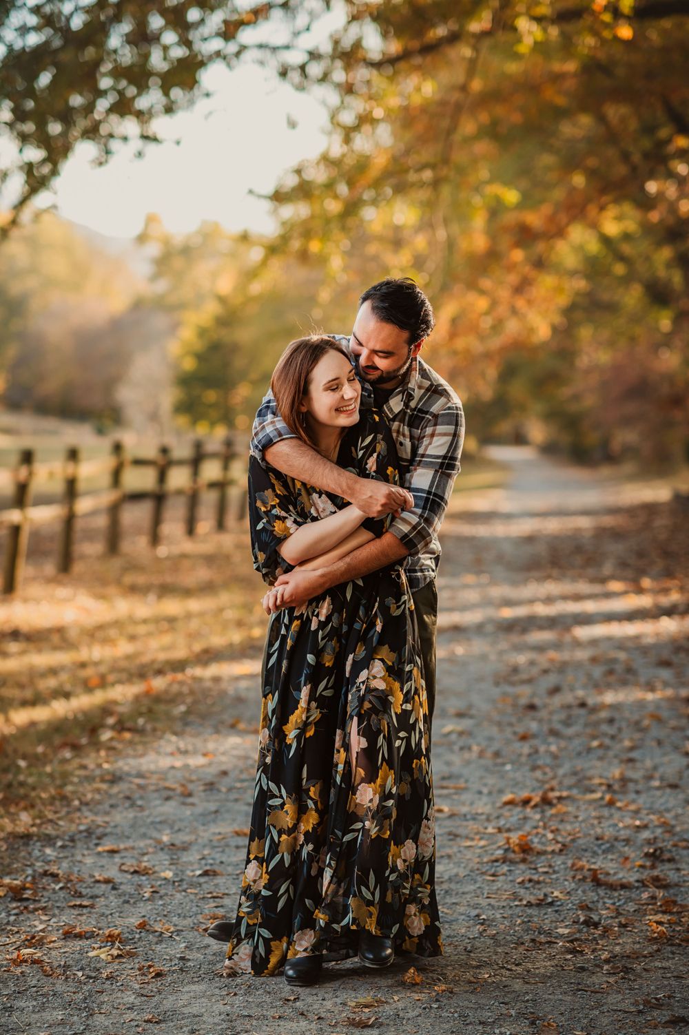 chattanooga mini sessions with fall leaves. a couple hugs on a path surrounded by beautiful fall colors