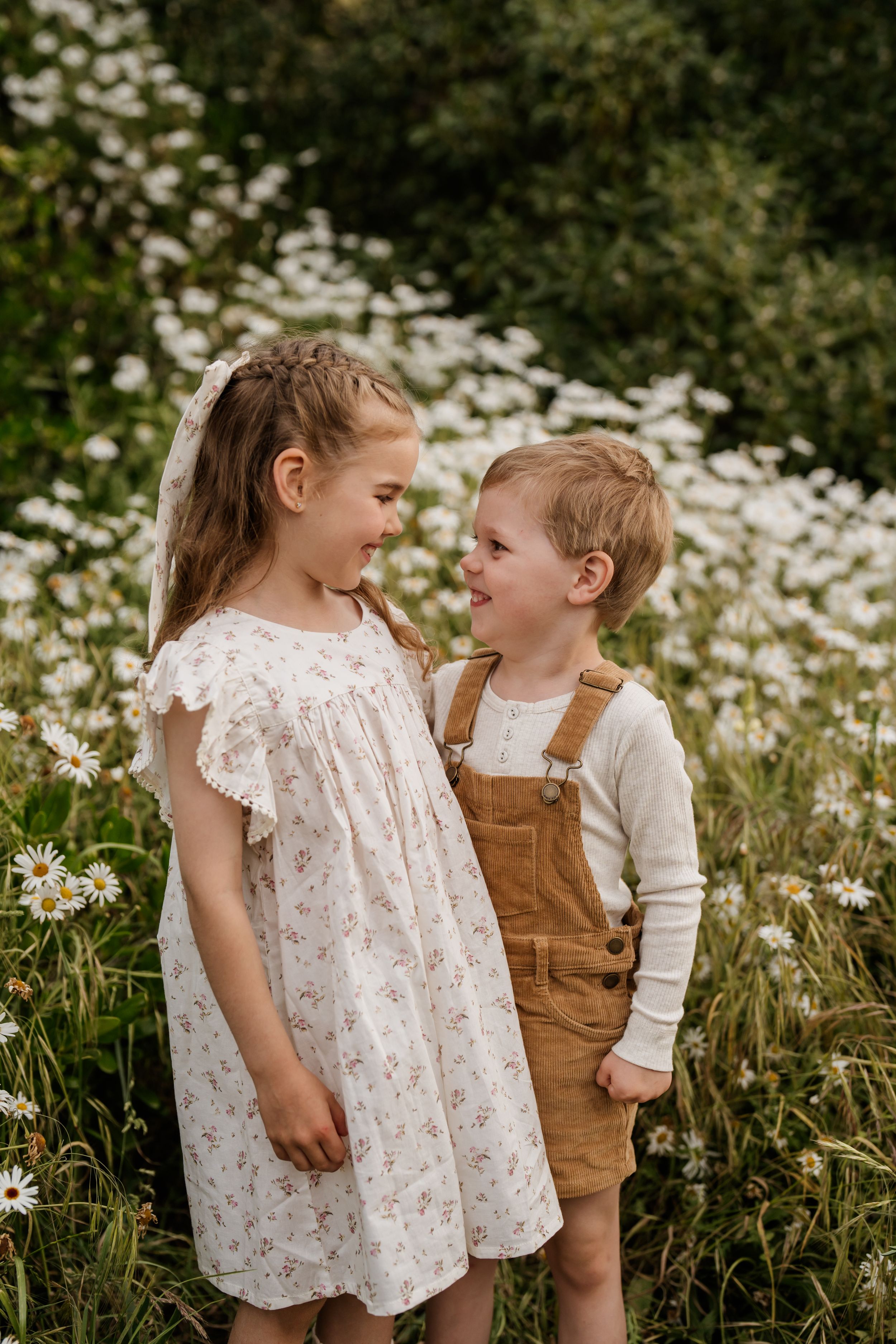 Brother and sister sharing a moment together during an outdoor family photography session