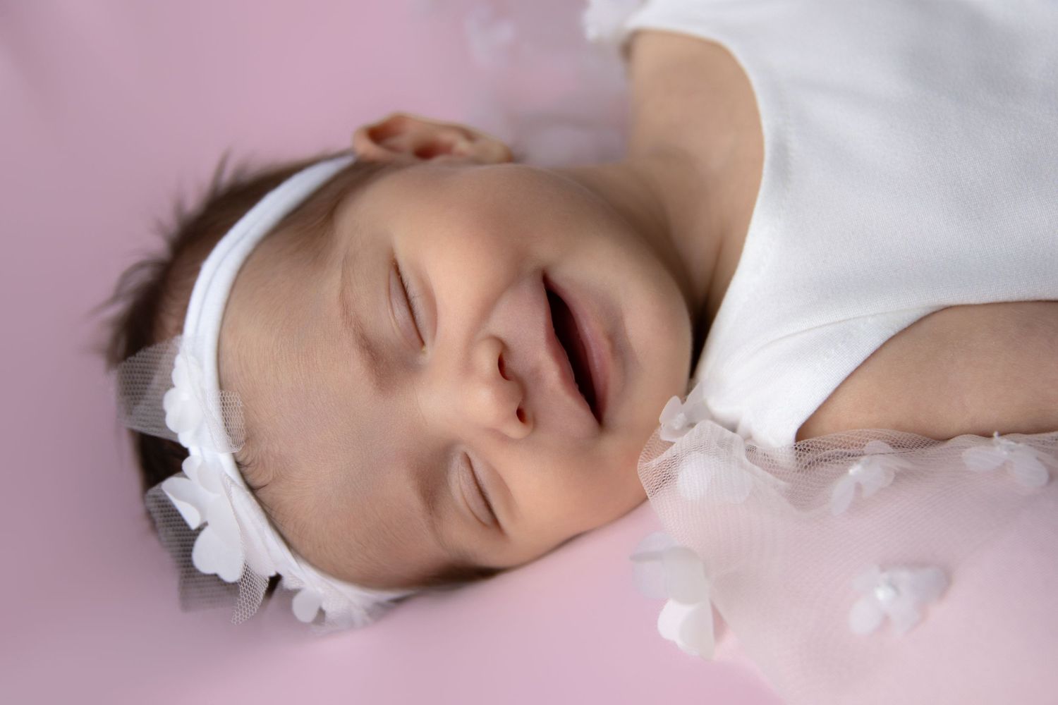 A series of close-up photos showing someone sleeping peacefully on white bedding in soft lighting.